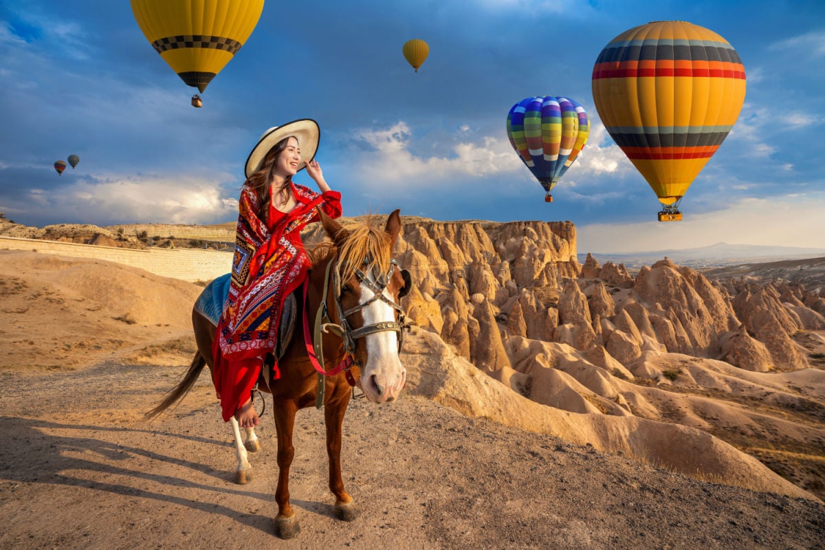 woman riding a horse in Cappadocia, Turkey
